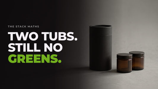 One tall unlabelled tub beside two smaller jars on a dark studio backdrop. Headline: Two tubs. Still no greens.