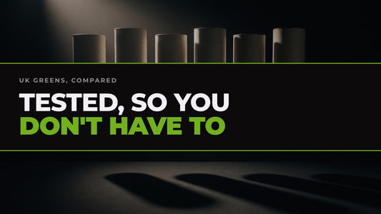 Six unbranded greens powder containers lit in a row against black, captioned “Tested, so you don't have to”.