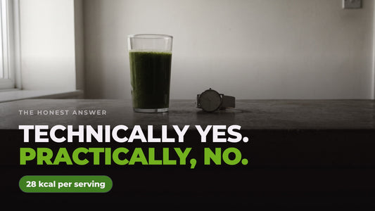 A glass of dark green drink beside a wristwatch on a kitchen worktop in morning light, captioned “Technically yes. Practically, no.” alongside a note reading 28 kcal per serving.