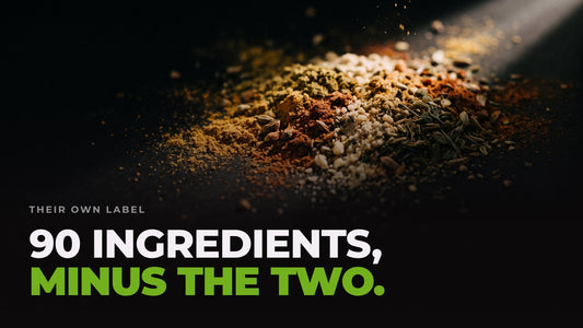 A drift of dozens of different coloured powders and seeds mixed together under a hard light. Headline: 90 ingredients, minus the two.