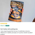 Hand holding a package of 'Good Fats' Omega 3 supplement by Lean Greens with a five-star review below.