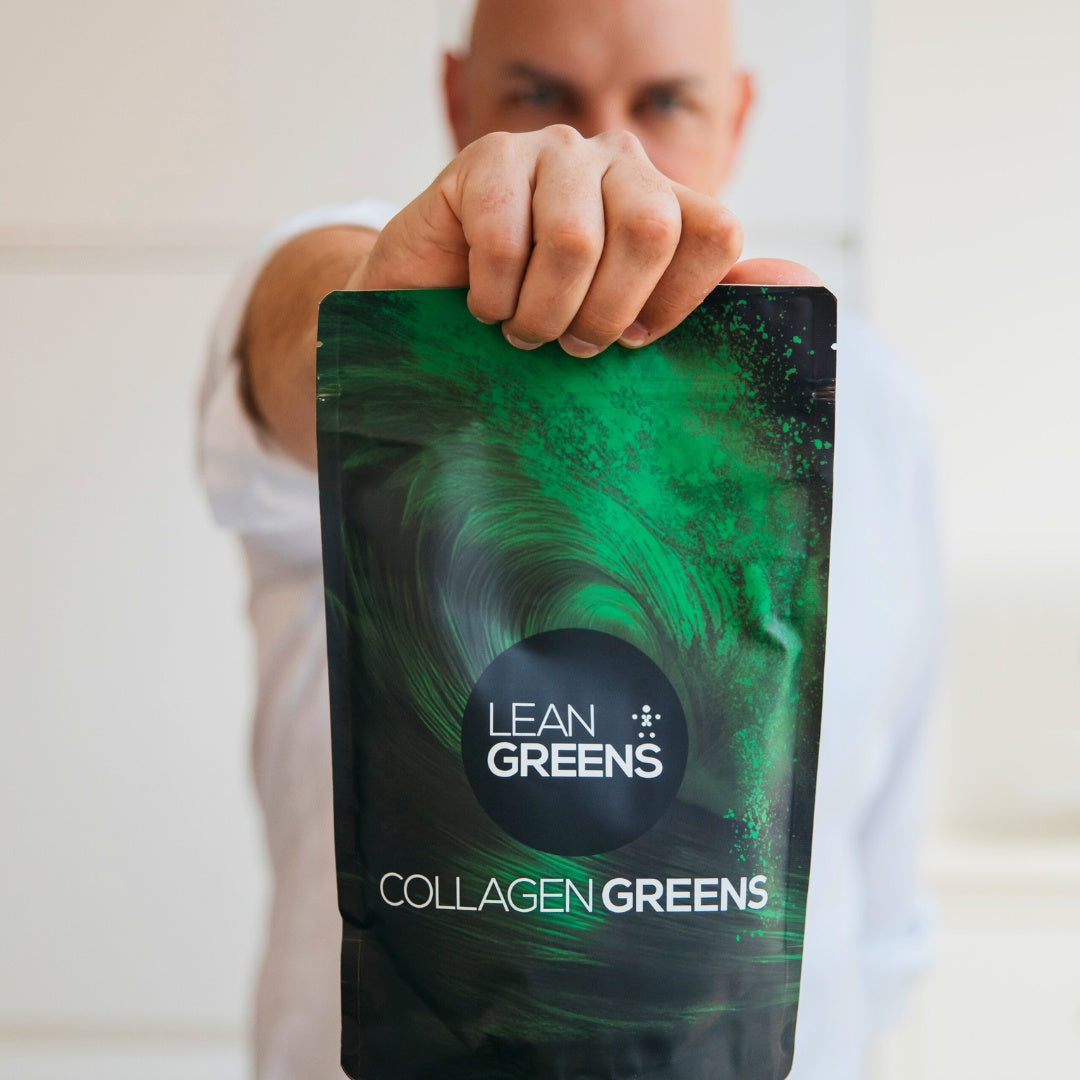 Person holding a package of Lean Greens Collagen Greens supplement. Cheaper alternative to AG1 UK