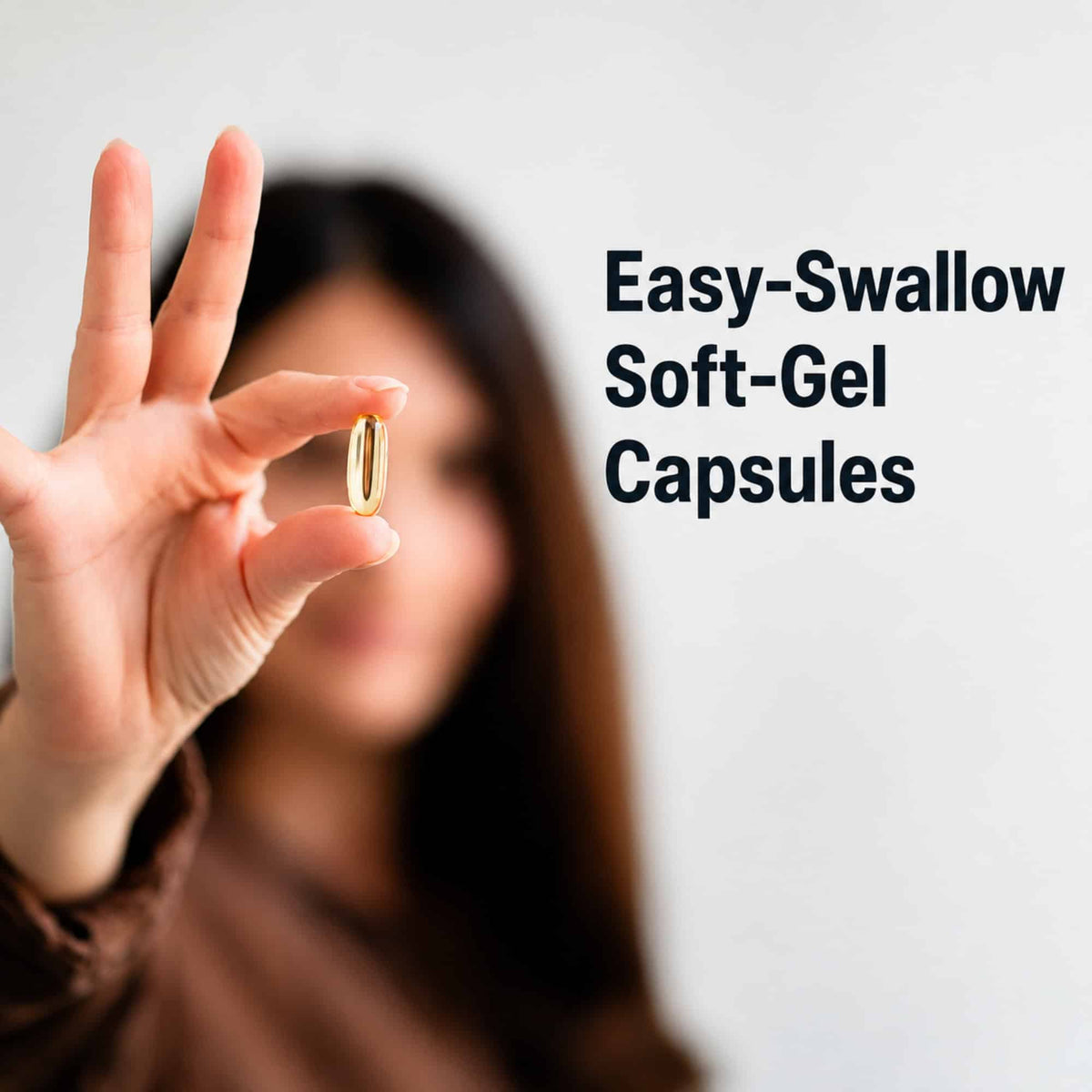 A woman holding up a single golden Good Fats soft-gel capsule, captioned "Easy-swallow soft-gel capsules".