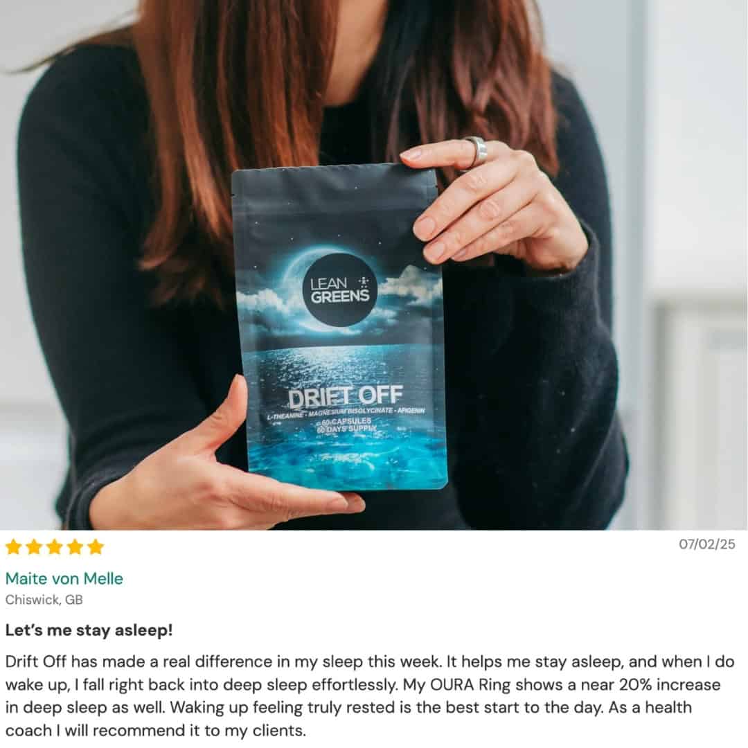 Person holding a 'Lean Greens Drift Off' package with a blurred background and 5 star review for the product