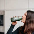Drinking a greens powder drink