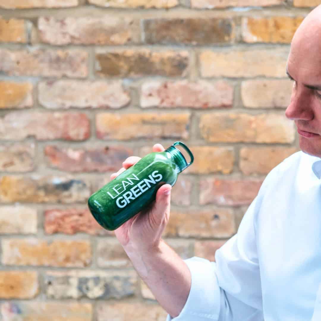 Tim Goodwin Mixing Lean Greens against the backdrop of a brick wall
