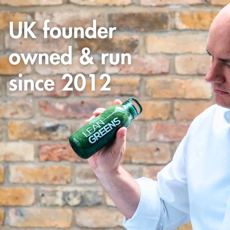 Person holding a green 'Lean Greens' bottle with text about UK ownership and founding year.